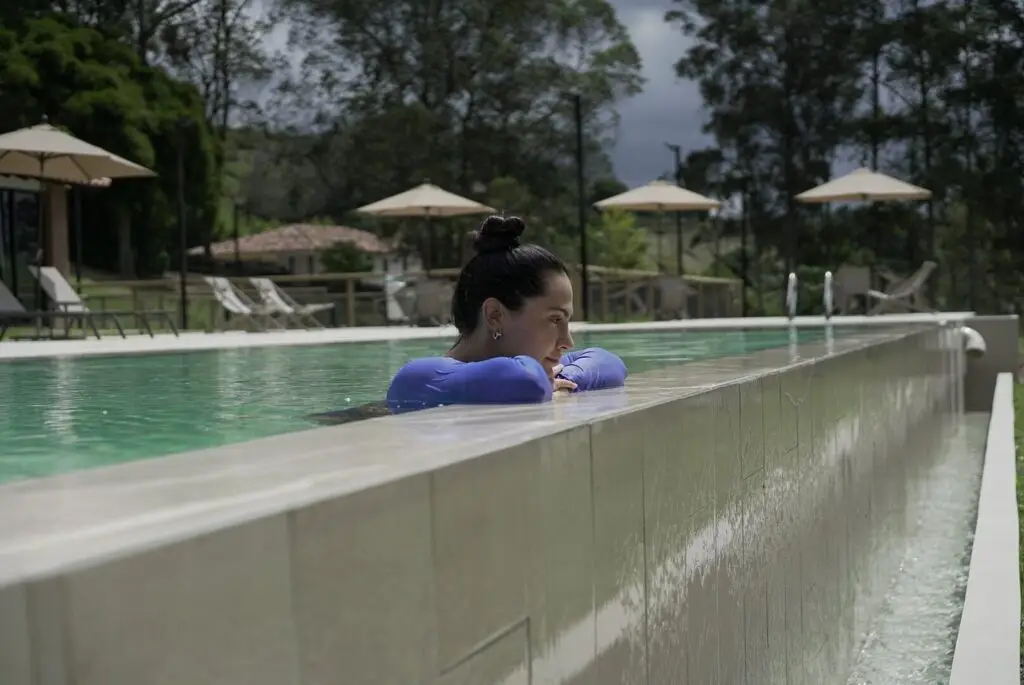 A guest resting at the edge of the infinity pool
