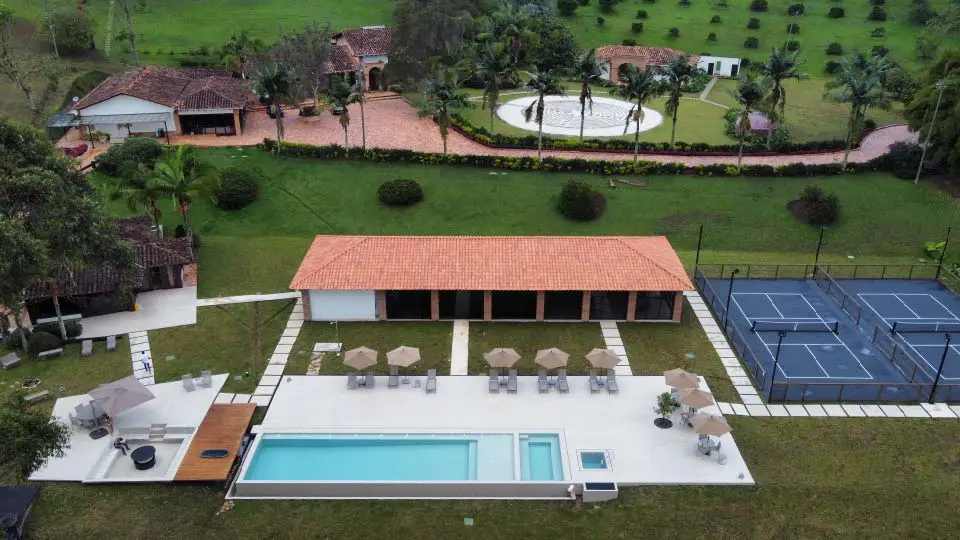 Aerial view of the main house, pool and courts