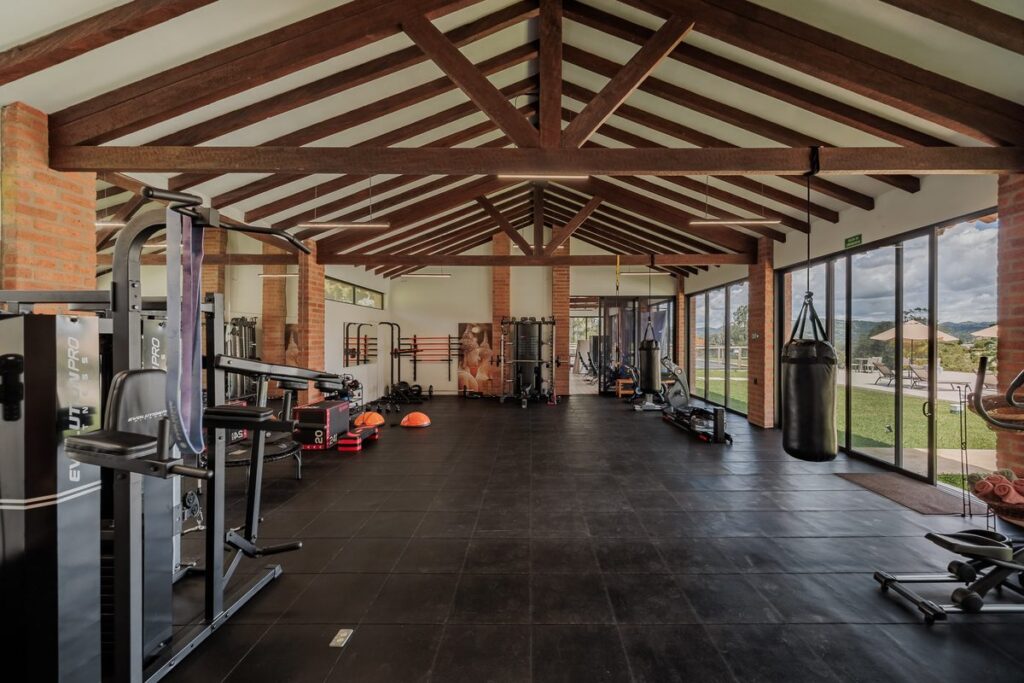The conditioning space under its timber roof, machines and weights laid out along the open side
